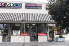 Thumbnail for Strip mall storefronts featuring State Farm insurance office and Kids Shoes shop under a striped awning with street lamp.