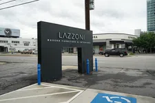 Thumbnail for Lazzoni Modern Furniture & Interiors black sign near street with Sephora store and cars in background on cloudy day