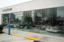 Thumbnail for Exterior view of LAZZONI furniture store with glass facade, showcasing modern sofas and a 40% off sale sign.