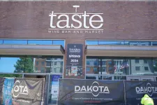 Thumbnail for Taste Wine Bar and Market exterior with construction banners for Dakota at a building site in daylight.