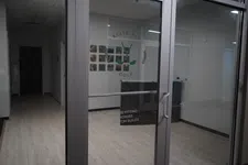 Thumbnail for Glass entrance door to Elite Fit Golf featuring club fitting, repairs, and custom builds services inside.