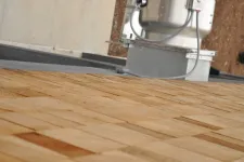 Thumbnail for Close-up of a wooden shingle roof with part of a rooftop air conditioning unit in the background.