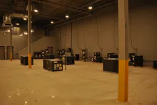 Thumbnail for Spacious industrial warehouse with HVAC units on polished concrete floor and high ceiling with lighting.