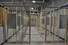 Thumbnail for Indoor gun shooting range with multiple target stations and hanging metal target frames inside a large industrial space.