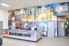 Thumbnail for Reception area of Tulsa Welding School with large mural reading 'A Way of Life A Badge of Honor' and people welding images.