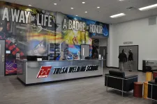 Thumbnail for Interior of Tulsa Weld Tech School with a reception desk and wall mural displaying motivational phrases.