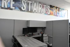 Thumbnail for Modern office cubicle with dual monitors, ergonomic chair, and motivational RE STARTS HERE banner above