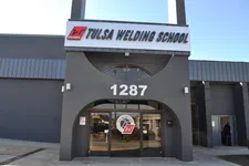 Thumbnail for Entrance of Tulsa Welding School building with address 1287 and school logo on glass doors under clear sky.