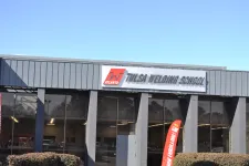 Thumbnail for Exterior view of Tulsa Welding School building with signage and clear blue sky on a sunny day.