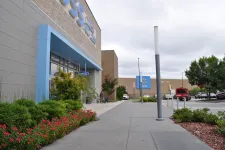 Thumbnail for Outdoor view of a Ross Dress for Less store entrance with landscaping and a Walmart in the background under cloudy sky