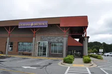 Thumbnail for Exterior view of Louisiana Bistreaux restaurant with parking lot and cloudy sky background
