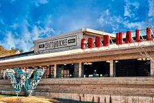 Thumbnail for Exterior of Chattahoochee Food Works Food Hall with large bold signage and artistic installation under blue sky