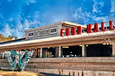 Thumbnail for Chattahoochee Food Works building with red Food Hall sign under a bright blue sky.