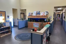 Thumbnail for Bright school hallway with a large aquarium, colorful decorations, and visible classroom doors and corridor.