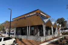 Thumbnail for Modern restaurant building with unique angled roof and signage for Killer Burgers and Grindhouse on sunny day.