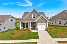 Thumbnail for Modern single-family home with gray siding, white trim, and a one-car garage on a sunny day.