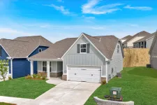 Thumbnail for Modern suburban houses with manicured lawns and clear blue sky on a sunny day