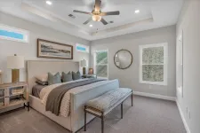 Thumbnail for Modern bedroom with plush bed, patterned bench, ceiling fan, two windows, and minimalistic decor in soft tones