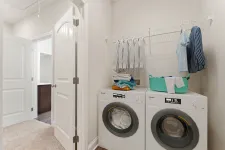 Thumbnail for a laundry room with a washing machine and towels on the wall