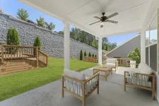 Thumbnail for a house with a patio and a large stone wall