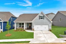 Thumbnail for Modern single-story gray house with a front porch and two-car garage on a sunny day