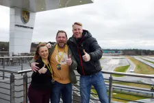 Thumbnail for a group of people posing for a photo on a bridge
