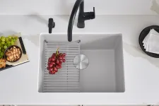 Thumbnail for a white kitchen sink with a black handle and a black handle