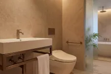 Thumbnail for Modern bathroom with wall-mounted sink, smart toilet, beige tiles, towel rack, and frosted glass door.