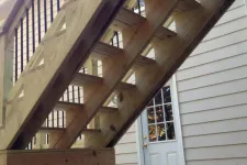 Thumbnail for a wooden staircase next to a house
