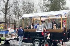 Thumbnail for a group of people standing on a truck with a sign