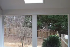 Thumbnail for a white porch with a railing and trees outside