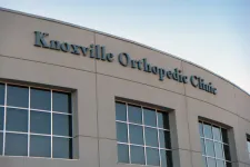 Thumbnail for Exterior of Knoxville Orthopedic Clinic building with large windows under a clear sky.