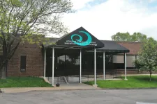 Thumbnail for Brick medical building with a black awning and sign reading advanced endoscopy center specialists in gastroenterology.