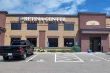 Thumbnail for Exterior view of Retina Center medical building with parking lot and black pickup truck under blue sky