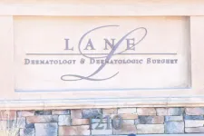 Thumbnail for Stone sign for Lane Dermatology & Dermatologic Surgery with address number 1210 on brick base.