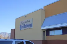 Thumbnail for Exterior view of Specialists in Dermatology clinic with clear blue sky and mountain backdrop.