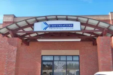 Thumbnail for Entrance of Southeastern Orthopedic Center with brick walls and curved metal awning above the glass door.