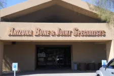 Thumbnail for Building entrance with Arizona Bone & Joint Specialists signage above doorway and handicap parking signs in front.