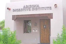 Thumbnail for Exterior view of Arizona Digestive Institute with wooden door and window in Suite B of stucco building.