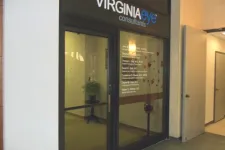 Thumbnail for Glass entrance doors of Virginia Eye Consultants with visible office interior and potted plant inside.