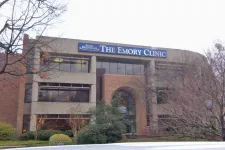 Thumbnail for Exterior view of The Emory Clinic building with trees and bushes in front during winter.