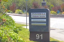 Thumbnail for Sign for Peninsula Dialysis Access and Peninsula Sleep Lab LLC at 91 on a sunny street corner with greenery.