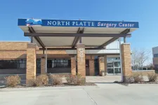 Thumbnail for Entrance of North Platte Surgery Center with brick pillars and covered walkway under a clear blue sky