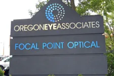 Thumbnail for Oregon Eye Associates sign with blue circular logo and Focal Point Optical text on black background.