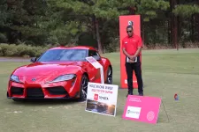 Thumbnail for a person standing next to a red sports car