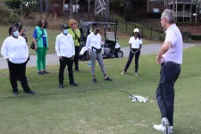 Thumbnail for a group of people playing golf