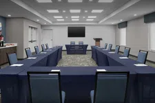 Thumbnail for Modern U-shaped conference room with navy table covers, blue chairs, podium, and large screen on white wall.
