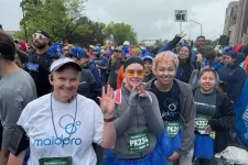 Thumbnail for Group of diverse runners in race gear and blue tutus smiling and posing before the Bolder Boulder race.