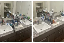 Thumbnail for Bathroom sink countertop cluttered with various toiletries, bottles, and medications next to a large mirror.