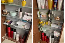 Thumbnail for Open wooden cabinet with glass shelves filled with skincare, haircare products, and medication boxes.